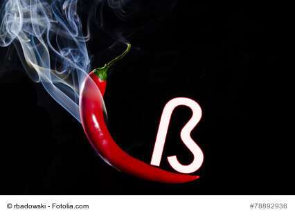 Smoking red hot chili pepper on black background